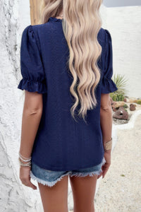 Woman wearing Embroidery Ruffle Sleeve Loose Fit Blouse-Add a touch of charm to your everyday look with this round neck embroidered shirt, featuring ruffle sleeves and a relaxed silhouette and intricate embroidery.