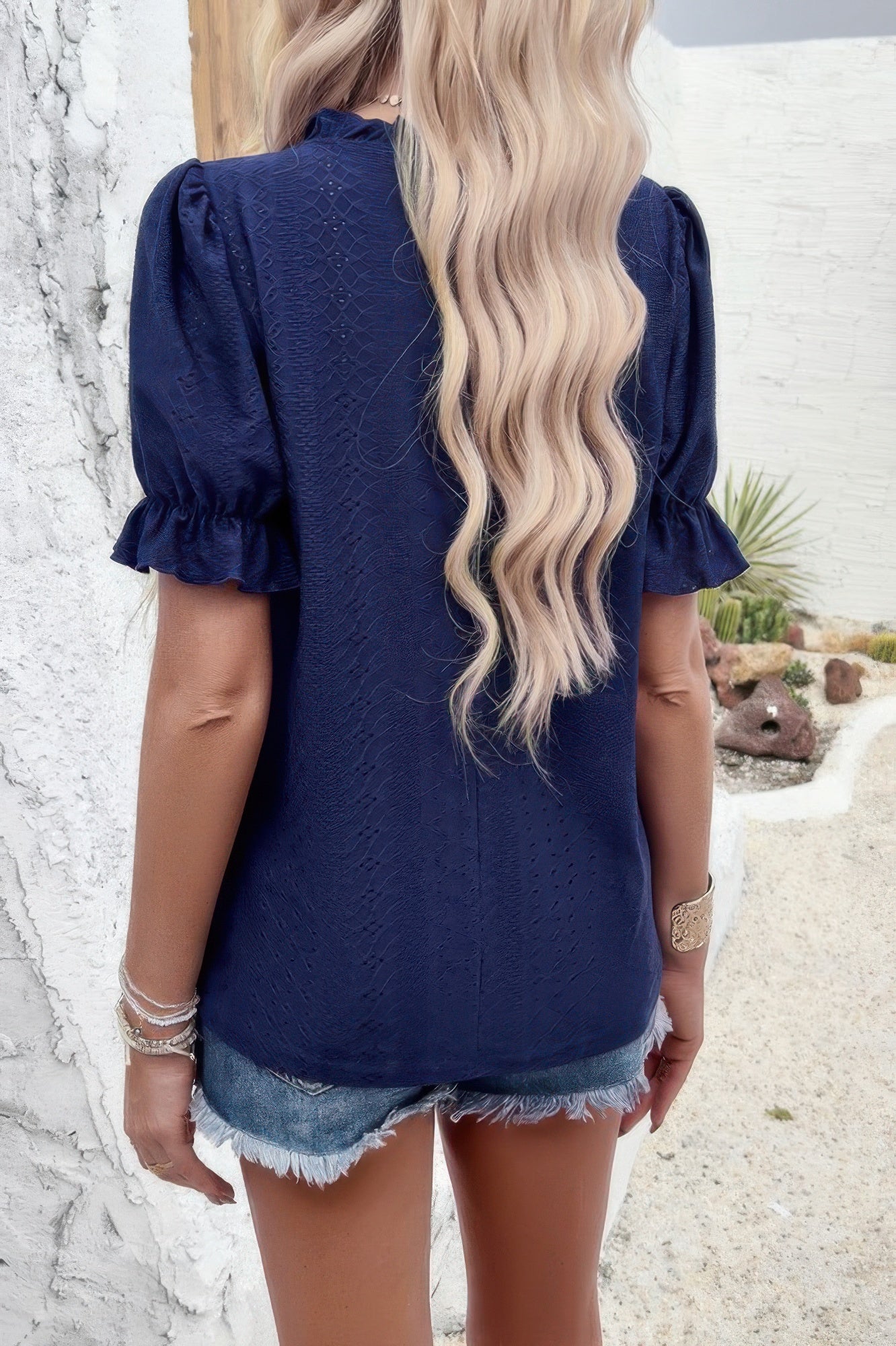 Woman wearing Embroidery Ruffle Sleeve Loose Fit Blouse-Add a touch of charm to your everyday look with this round neck embroidered shirt, featuring ruffle sleeves and a relaxed silhouette and intricate embroidery.