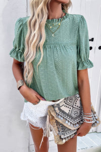 Woman wearing Embroidery Ruffle Sleeve Loose Fit Blouse-Add a touch of charm to your everyday look with this round neck embroidered shirt, featuring ruffle sleeves and a relaxed silhouette and intricate embroidery.