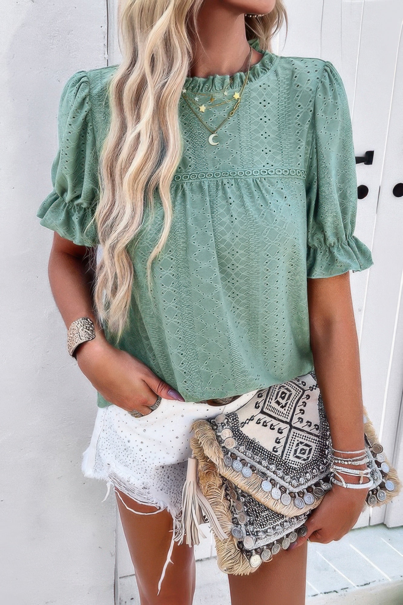 Woman wearing Embroidery Ruffle Sleeve Loose Fit Blouse-Add a touch of charm to your everyday look with this round neck embroidered shirt, featuring ruffle sleeves and a relaxed silhouette and intricate embroidery.