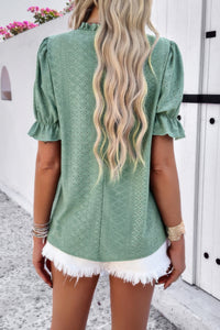Woman wearing Embroidery Ruffle Sleeve Loose Fit Blouse-Add a touch of charm to your everyday look with this round neck embroidered shirt, featuring ruffle sleeves and a relaxed silhouette and intricate embroidery.