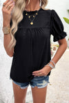 Woman wearing Embroidery Ruffle Sleeve Loose Fit Blouse-Add a touch of charm to your everyday look with this round neck embroidered shirt, featuring ruffle sleeves and a relaxed silhouette and intricate embroidery.