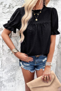 Woman wearing Embroidery Ruffle Sleeve Loose Fit Blouse-Add a touch of charm to your everyday look with this round neck embroidered shirt, featuring ruffle sleeves and a relaxed silhouette and intricate embroidery.