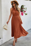 Woman wearing Sleeveless Dot Print Cross Fit Pleated Dress-Step into effortless charm with this Sleeveless Dot Print Cross Fit Pleated Dress. Featuring a playful dot print paired with a flattering cross-fit bodice