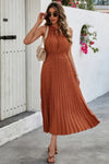 Woman wearing Sleeveless Dot Print Cross Fit Pleated Dress-Step into effortless charm with this Sleeveless Dot Print Cross Fit Pleated Dress. Featuring a playful dot print paired with a flattering cross-fit bodice