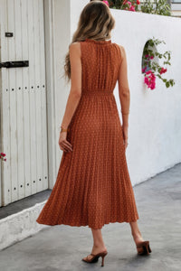 Woman wearing Sleeveless Dot Print Cross Fit Pleated Dress-Step into effortless charm with this Sleeveless Dot Print Cross Fit Pleated Dress. Featuring a playful dot print paired with a flattering cross-fit bodice