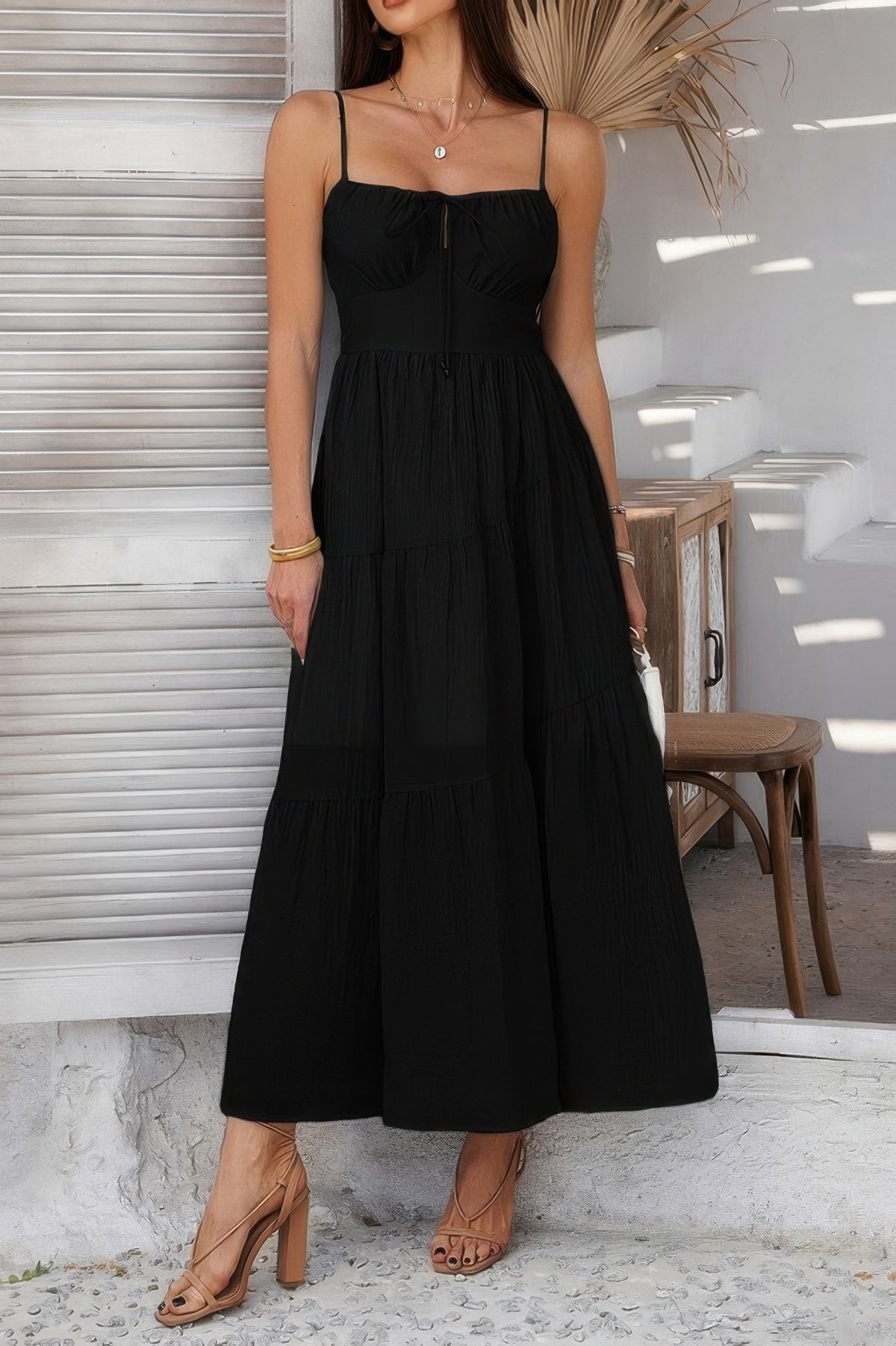 Woman wearing Sleeveless Smocked Tiered Maxi Dress-Breeze through sunny days in this Solid Sleeveless Smocked Tiered Maxi Cami Dress. Offering a flowy, feminine silhouette with effortless comfort. 