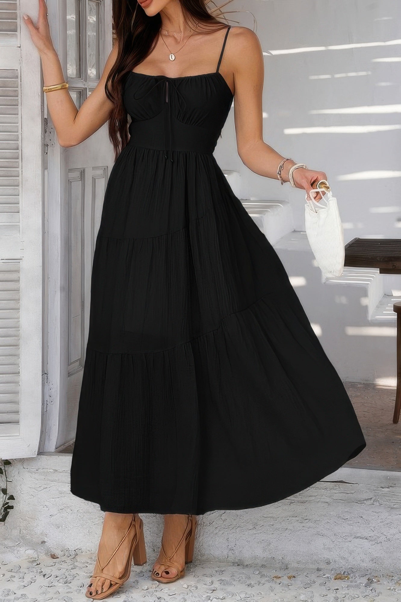 Woman wearing Sleeveless Smocked Tiered Maxi Dress-Breeze through sunny days in this Solid Sleeveless Smocked Tiered Maxi Cami Dress. Offering a flowy, feminine silhouette with effortless comfort. 