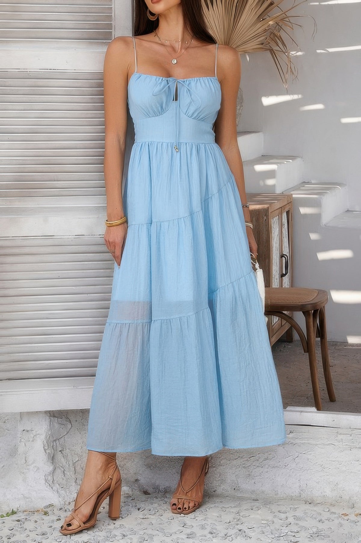 Woman wearing Sleeveless Smocked Tiered Maxi Dress-Breeze through sunny days in this Solid Sleeveless Smocked Tiered Maxi Cami Dress. Offering a flowy, feminine silhouette with effortless comfort. 