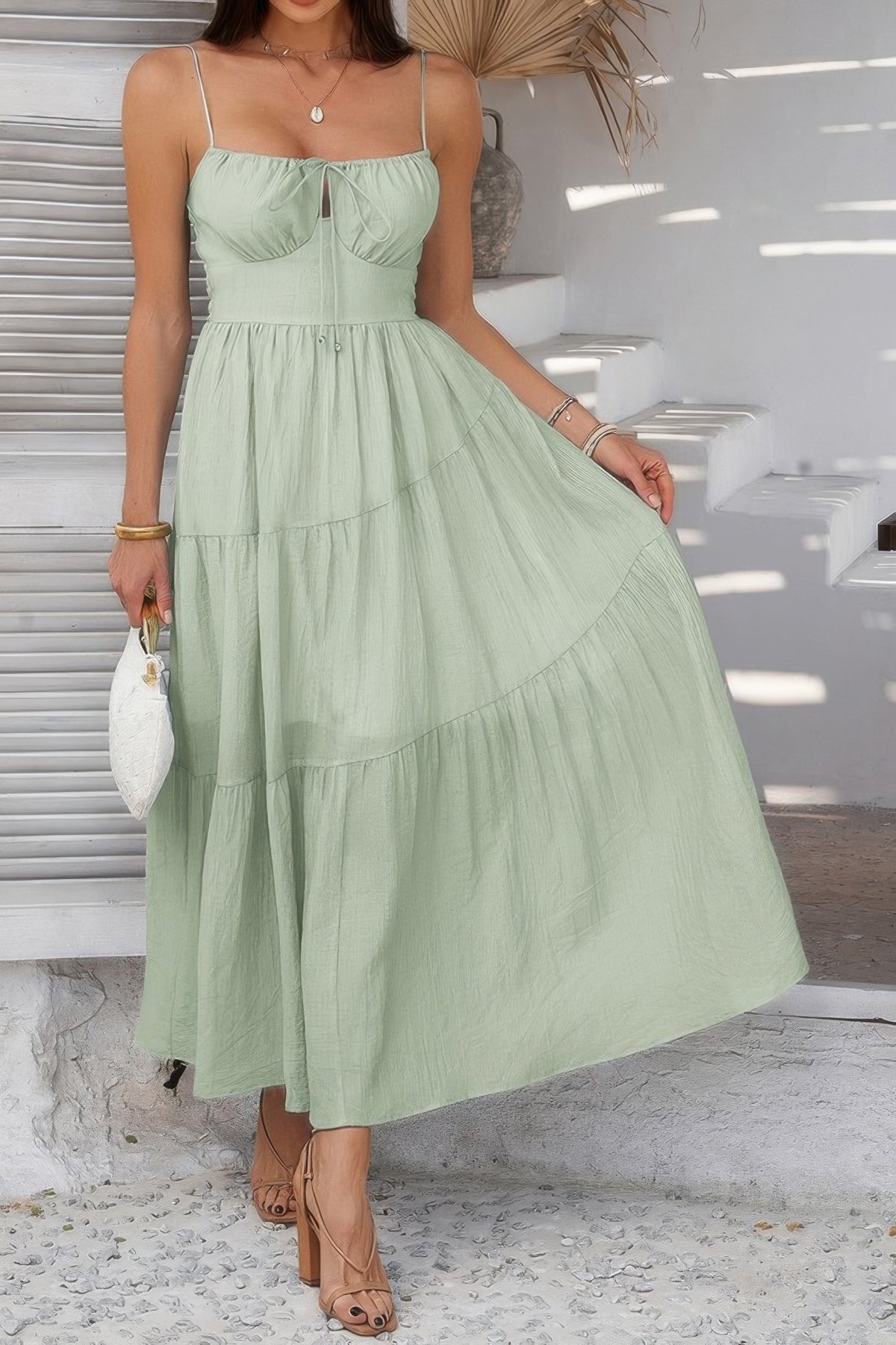 Woman wearing Sleeveless Smocked Tiered Maxi Dress-Breeze through sunny days in this Solid Sleeveless Smocked Tiered Maxi Cami Dress. Offering a flowy, feminine silhouette with effortless comfort. 