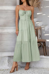 Woman wearing Sleeveless Smocked Tiered Maxi Dress-Breeze through sunny days in this Solid Sleeveless Smocked Tiered Maxi Cami Dress. Offering a flowy, feminine silhouette with effortless comfort. 