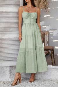 Woman wearing Sleeveless Smocked Tiered Maxi Dress-Breeze through sunny days in this Solid Sleeveless Smocked Tiered Maxi Cami Dress. Offering a flowy, feminine silhouette with effortless comfort. 
