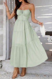 Woman wearing Sleeveless Smocked Tiered Maxi Dress-Breeze through sunny days in this Solid Sleeveless Smocked Tiered Maxi Cami Dress. Offering a flowy, feminine silhouette with effortless comfort. 