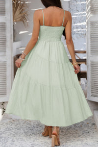 Woman wearing Sleeveless Smocked Tiered Maxi Dress-Breeze through sunny days in this Solid Sleeveless Smocked Tiered Maxi Cami Dress. Offering a flowy, feminine silhouette with effortless comfort. 