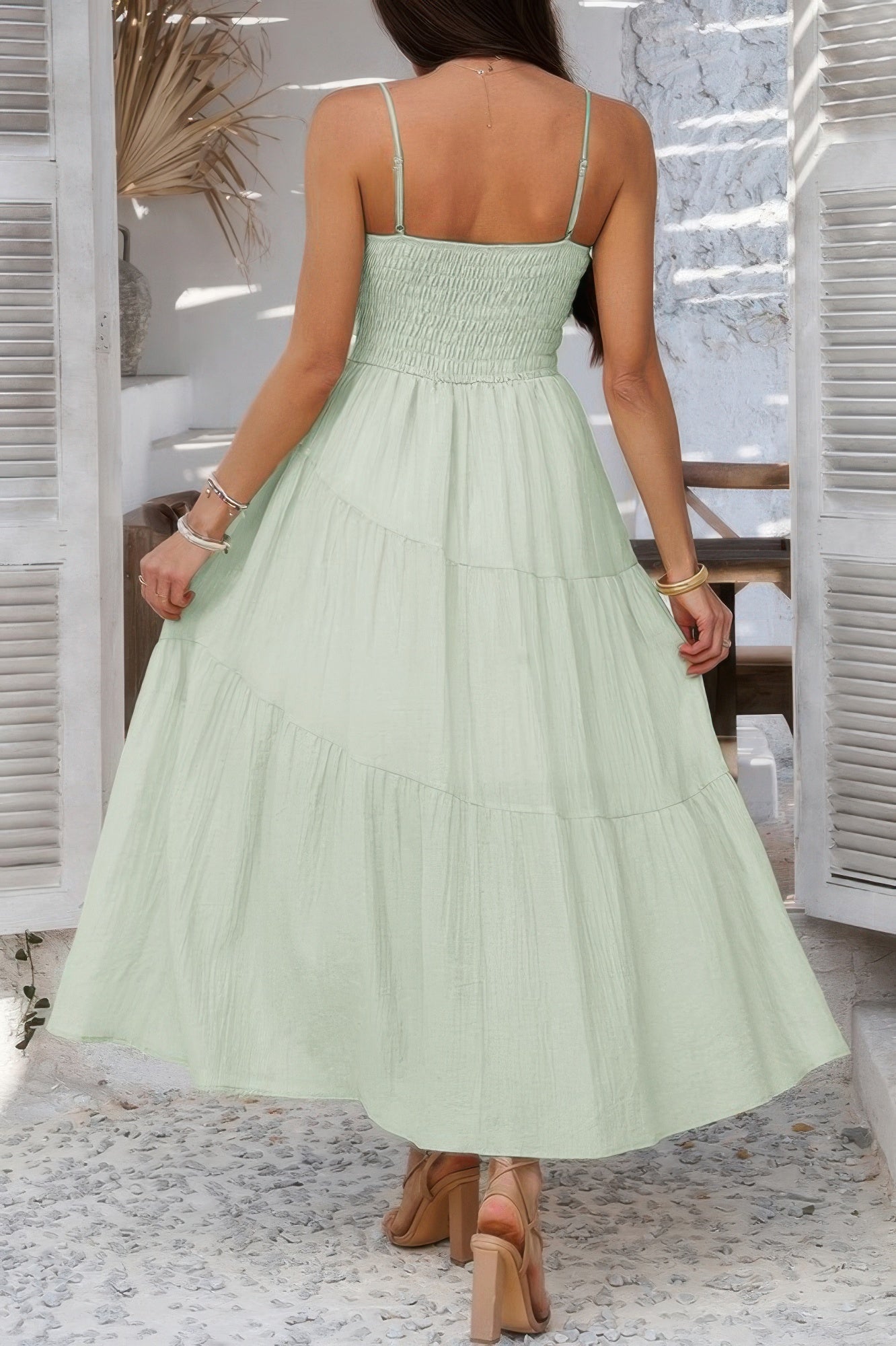 Woman wearing Sleeveless Smocked Tiered Maxi Dress-Breeze through sunny days in this Solid Sleeveless Smocked Tiered Maxi Cami Dress. Offering a flowy, feminine silhouette with effortless comfort. 