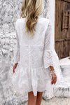 Woman wearing Button Flared Sleeve Hollow Out Lace Dress-Step into timeless elegance with this V-Neck Button Flared Sleeves Hollow Out Lace Dress, perfect for special occasions or everyday sophistication.