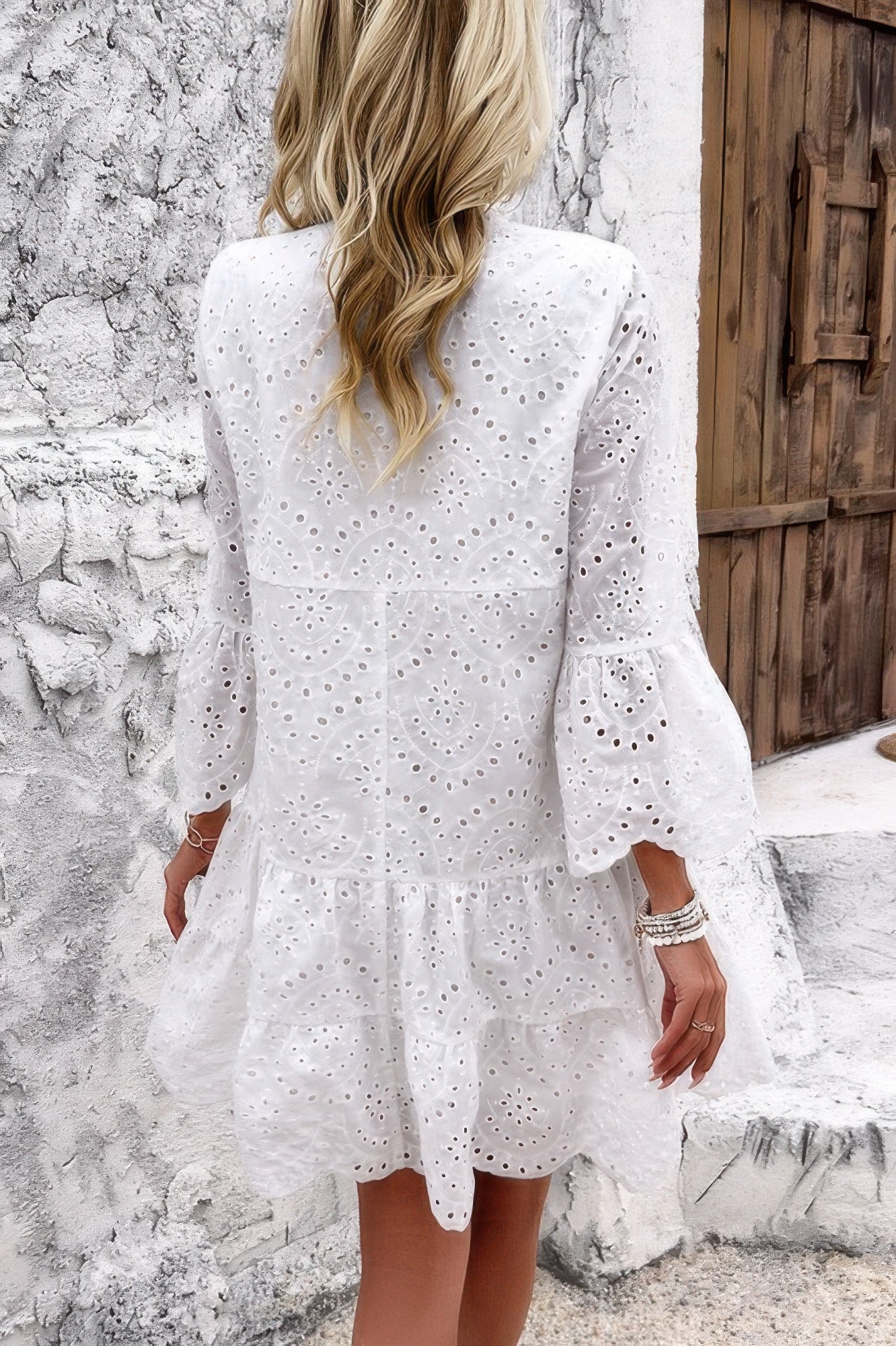 Woman wearing Button Flared Sleeve Hollow Out Lace Dress-Step into timeless elegance with this V-Neck Button Flared Sleeves Hollow Out Lace Dress, perfect for special occasions or everyday sophistication.