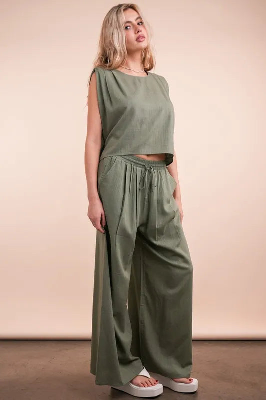 Women's Olive Green woven top and pants set is a versatile and chic outfit option that offers a coordinated and put-together look.