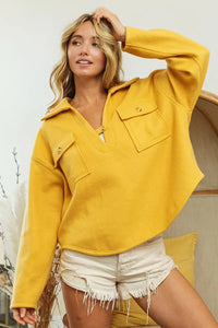 Woman wearing Honey Mustard Fleece Collared Sweatshirt-Fleece collared sweatshirt with flap pockets and button details. Cozy, stylish, and perfect for layering all season long, your new cozy fall favorite.