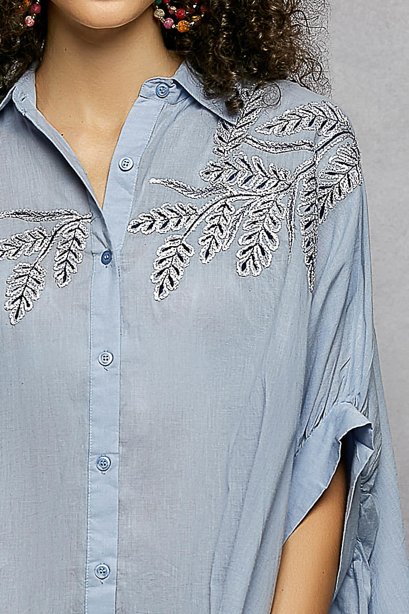 Sky blue 100% cotton POL button-down shirt with intricate leaf embroidery, voluminous draped sleeves, and a tailored collar.