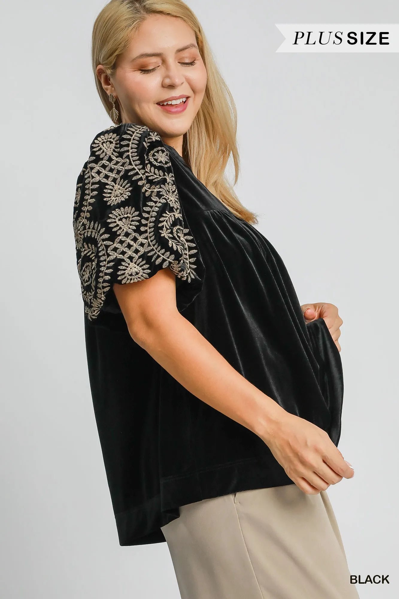 Woman wearing Velvet Embroidered Sleeve Blouse-This velvet embroidered sleeve blouse combines luxe velvet with embroidery for a sophisticated and stylish look. Perfect for adding a touch of glamour to your outfit.