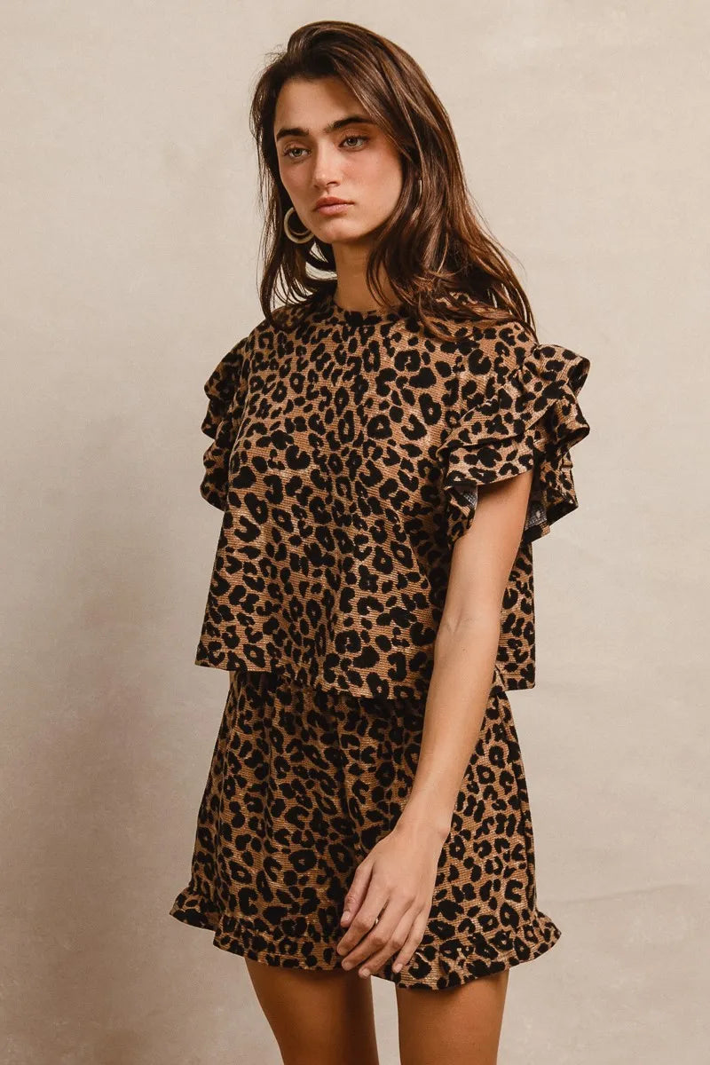 Woman wearing Leopard Print Waffle Texture Layered Ruffle Sleeve Top and Shorts Set-This leopard print set features a leopard print waffle texture top with layered ruffle sleeves, paired with matching shorts for a coordinated and stylish look. 