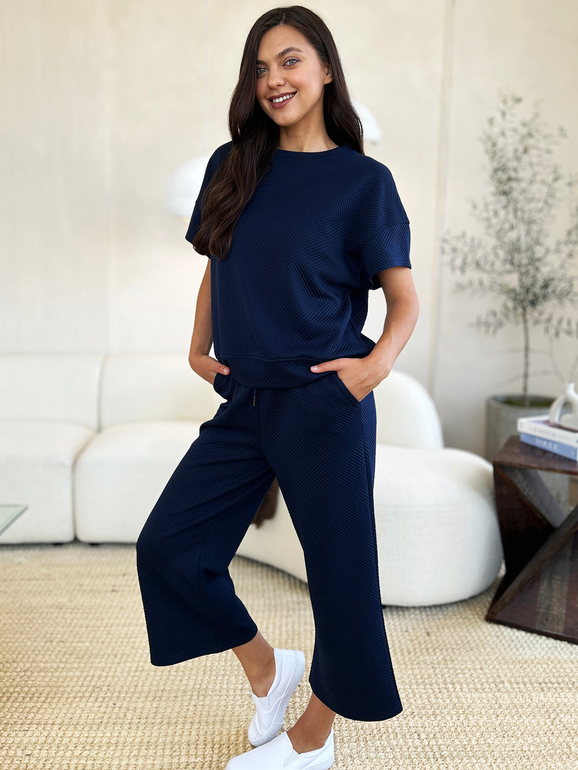 Textured, stretchy, and comfy. This two piece cropped pant with short sleeve top is a great travel set to stay comfortable in the car or plane. Available in a variety of colors and extended sizes.