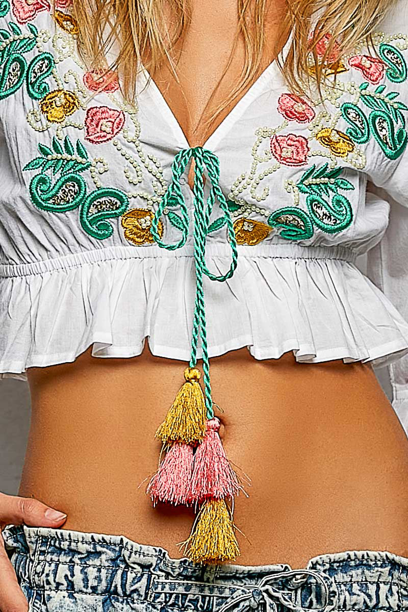 Boho Floral Embroidered Cropped V Neck Blouse with braided tie, tassels, and ruffled hem.