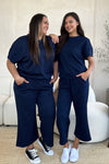 Textured, stretchy, and comfy. This two piece cropped pant with short sleeve top is a great travel set to stay comfortable in the car or plane. Available in a variety of colors and extended sizes.