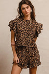 Woman wearing Leopard Print Waffle Texture Layered Ruffle Sleeve Top and Shorts Set-This leopard print set features a leopard print waffle texture top with layered ruffle sleeves, paired with matching shorts for a coordinated and stylish look. 