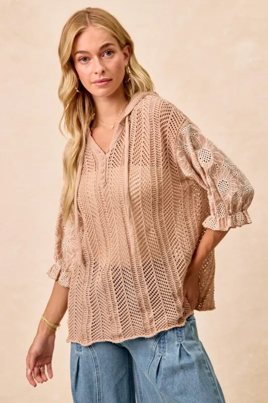 Woman wearing Jacquard Flower Puff Sleeve Hooded Knit Top-This jacquard flower puff sleeve hooded knit top combines intricate floral patterns with a touch of volume in the sleeves for a stylish look, elevate your knitwear.