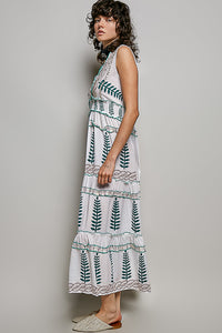 Ivory V-neck sleeveless tiered dress with leafy floral print, smocked waistband, and ruffle accents.
