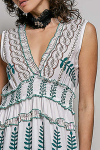 Ivory V-neck sleeveless tiered dress with leafy floral print, smocked waistband, and shirred ruffle accents.