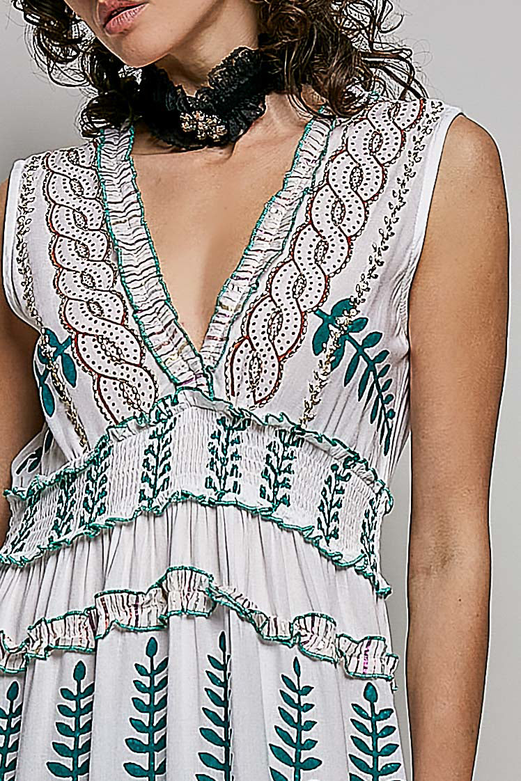 Ivory V-neck sleeveless tiered dress with leafy floral print, smocked waistband, and shirred ruffle accents.