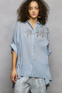Sky blue 100% cotton POL button-down shirt with intricate leaf embroidery, voluminous sleeves, and a high-low hem.