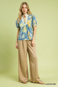 Vibrant Lagoon Mix floral print puff sleeve blouse with high neckline, perfect for warm weather.