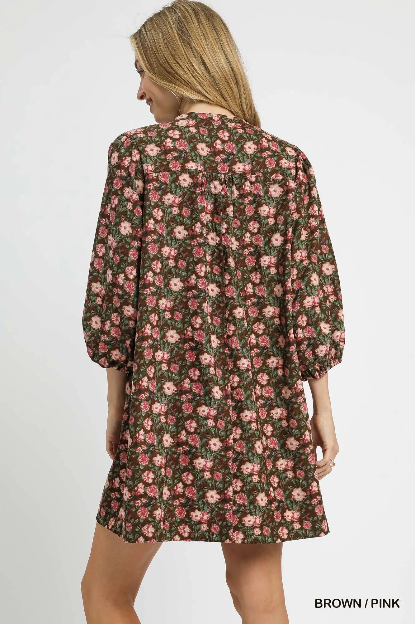 Woman wearing Fall Floral Tie-Neck Babydoll Dress-Fall floral tie-neck babydoll dress is a charming choice for any occasion. The tie-neck detail adds a touch of elegance to the sweet babydoll silhouette.