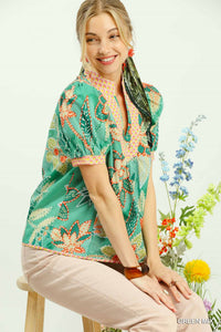 Fashionable green mixed abstract floral print puff sleeve blouse with V-neckline, made from 100% cotton.