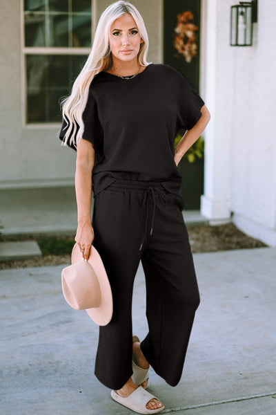 Textured, stretchy, and comfy. This two piece cropped pant with short sleeve top is a great travel set to stay comfortable in the car or plane. Available in a variety of colors and extended sizes.