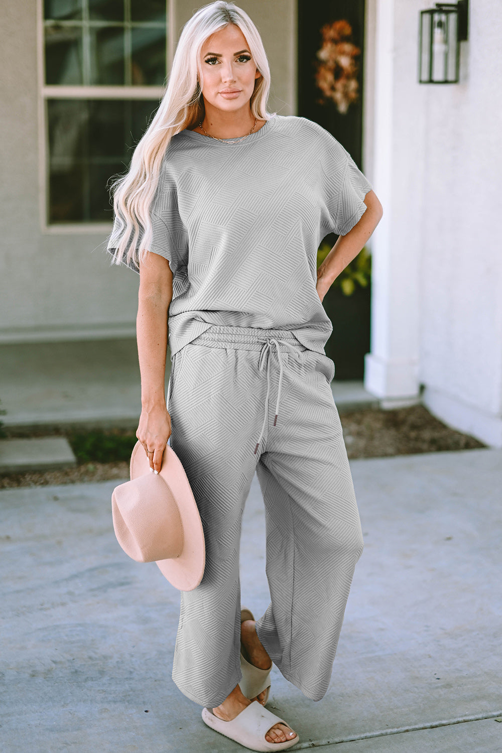 Textured, stretchy, and comfy. This two piece cropped pant with short sleeve top is a great travel set to stay comfortable in the car or plane. Available in a variety of colors and extended sizes.