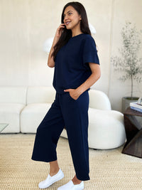 Textured, stretchy, and comfy. This two piece cropped pant with short sleeve top is a great travel set to stay comfortable in the car or plane. Available in a variety of colors and extended sizes.