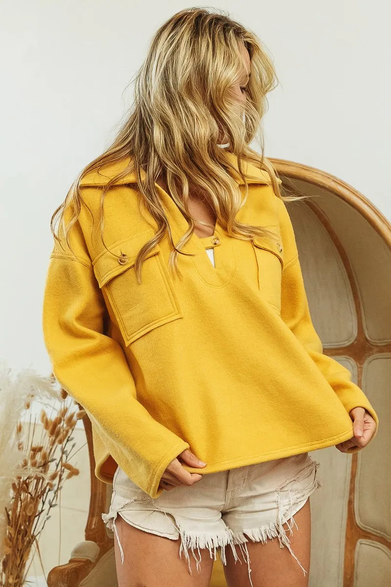 Woman wearing Honey Mustard Fleece Collared Sweatshirt-Fleece collared sweatshirt with flap pockets and button details. Cozy, stylish, and perfect for layering all season long, your new cozy fall favorite.