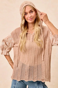 Woman wearing Jacquard Flower Puff Sleeve Hooded Knit Top-This jacquard flower puff sleeve hooded knit top combines intricate floral patterns with a touch of volume in the sleeves for a stylish look, elevate your knitwear.