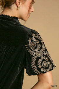 Woman wearing Velvet Embroidered Sleeve Blouse-This velvet embroidered sleeve blouse combines luxe velvet with embroidery for a sophisticated and stylish look. Perfect for adding a touch of glamour to your outfit.