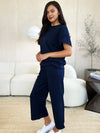 Textured, stretchy, and comfy. This two piece cropped pant with short sleeve top is a great travel set to stay comfortable in the car or plane. Available in a variety of colors and extended sizes.