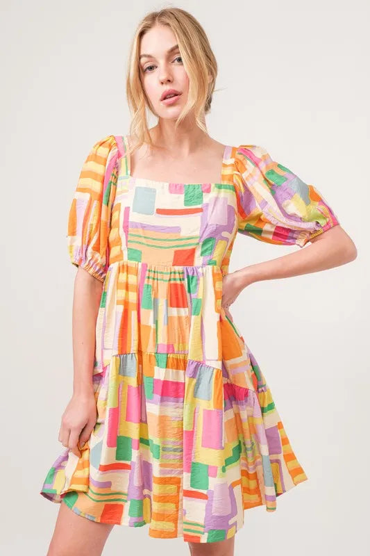 Square Neck Puff Sleeve Geo Printed Mini Dress-The square neck puff sleeve geo printed mini dress is a fashionable and eye-catching choice for a stylish ensemble. The square neckline adds a modern and chic touch-Reef Love Boho-Chic Boutique
