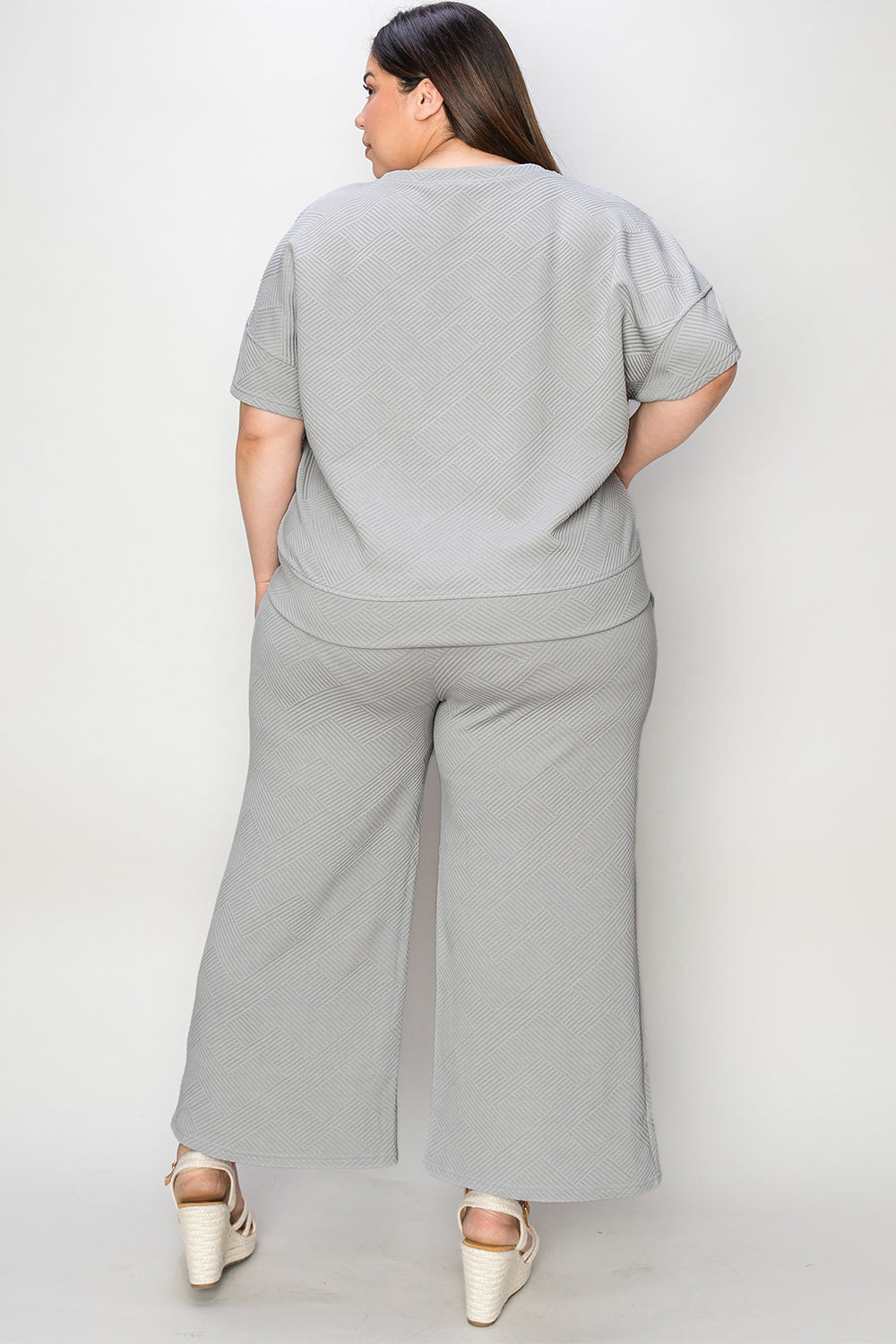 Textured, stretchy, and comfy. This two piece cropped pant with short sleeve top is a great travel set to stay comfortable in the car or plane. Available in a variety of colors and extended sizes.