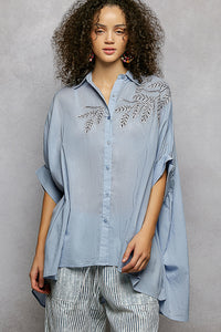 Sky blue 100% cotton POL button-down shirt with intricate leaf embroidery, voluminous sleeves, and a high-low hem.