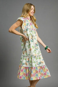 Woman wearing Patchwork Garden Midi Dress-Boho-inspired midi dress features a delightful floral print on flowing fabric that moves beautifully. perfect for warm weather, casual daywear to vacation styling. 
