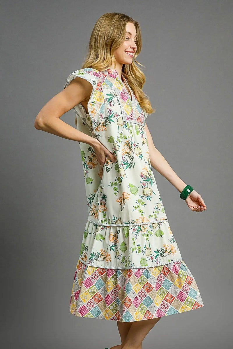 Woman wearing Patchwork Garden Midi Dress-Boho-inspired midi dress features a delightful floral print on flowing fabric that moves beautifully. perfect for warm weather, casual daywear to vacation styling. 